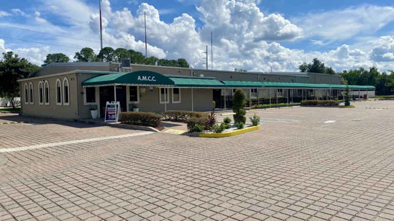 Exterior view of the AMCC building with green awnings and entrance